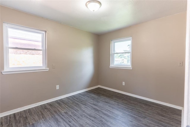 spare room with dark wood-type flooring