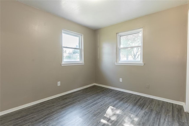 empty room with dark hardwood / wood-style floors