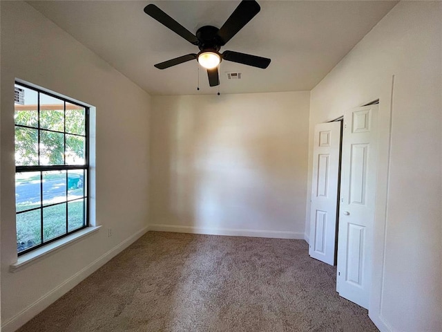 spare room with carpet and ceiling fan