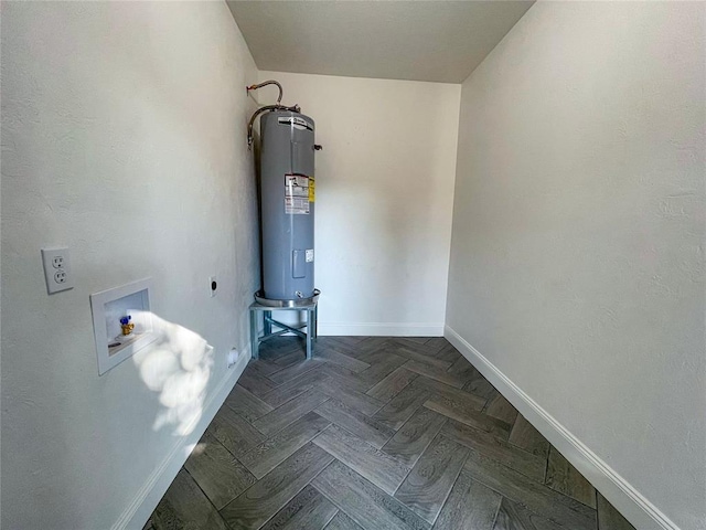 clothes washing area with hookup for an electric dryer, washer hookup, dark parquet flooring, and water heater