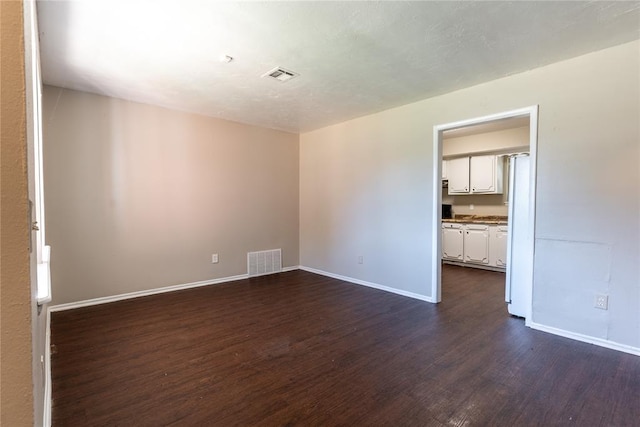 spare room with dark hardwood / wood-style floors