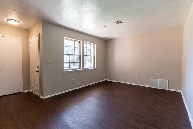 unfurnished room featuring dark hardwood / wood-style floors