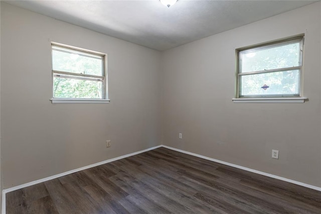 empty room with dark wood-type flooring