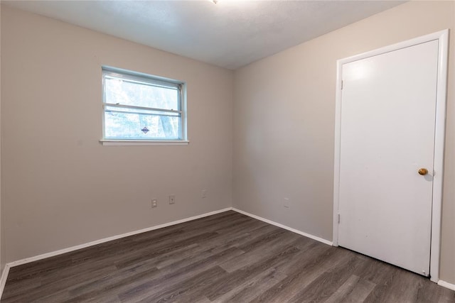 spare room featuring dark hardwood / wood-style flooring