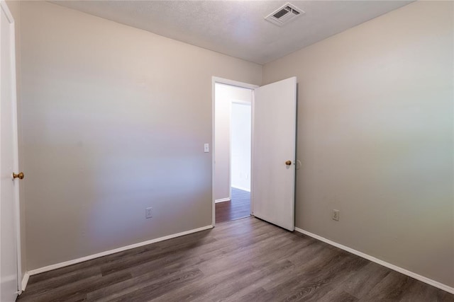 empty room featuring dark wood-type flooring