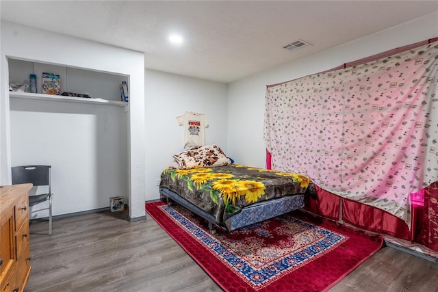 bedroom with hardwood / wood-style flooring