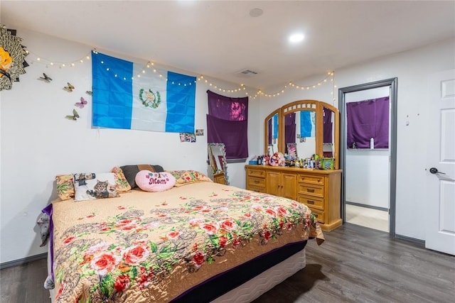 bedroom with dark hardwood / wood-style floors