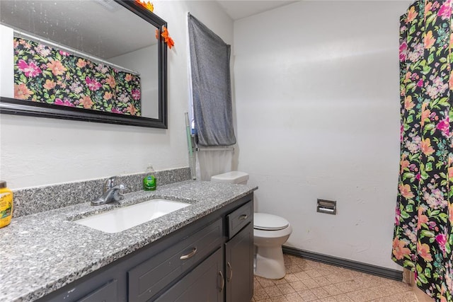 bathroom with toilet and vanity