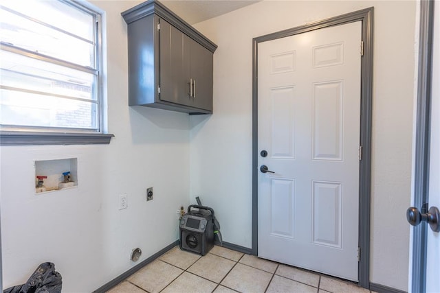 laundry room with cabinets, light tile patterned floors, hookup for a washing machine, and electric dryer hookup