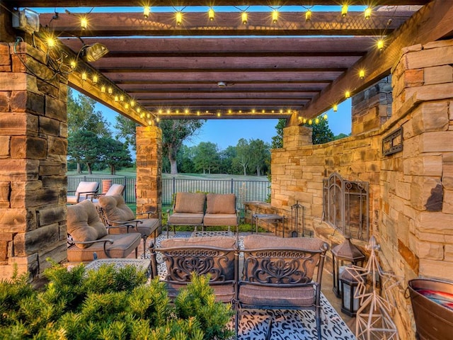 patio terrace at dusk featuring a pergola and outdoor lounge area