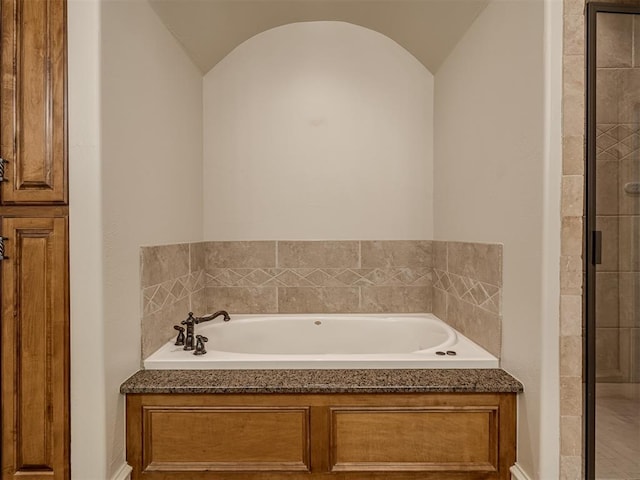 bathroom featuring vaulted ceiling and shower with separate bathtub