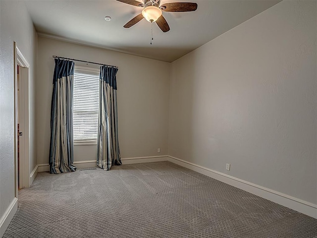 empty room with ceiling fan and carpet