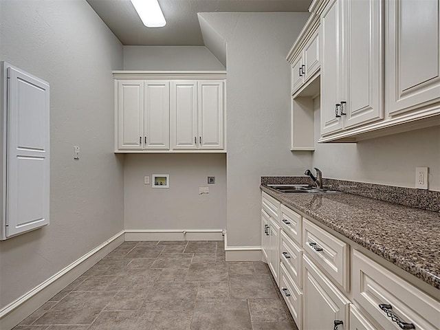 laundry area featuring hookup for a washing machine, sink, cabinets, and hookup for an electric dryer