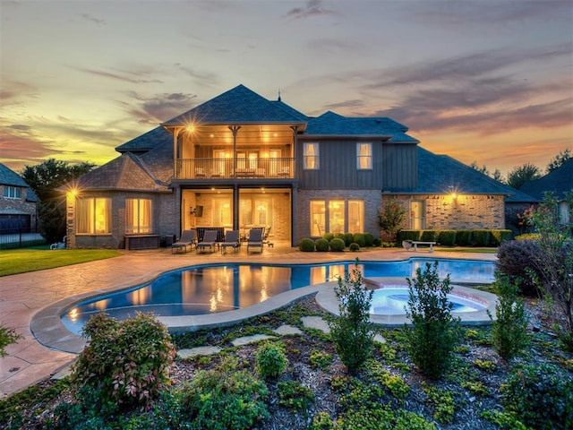 pool at dusk with a patio