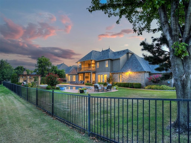 exterior space with an outdoor living space, a balcony, a yard, and a patio