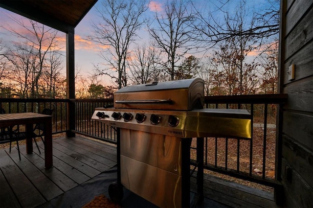 deck at dusk with grilling area