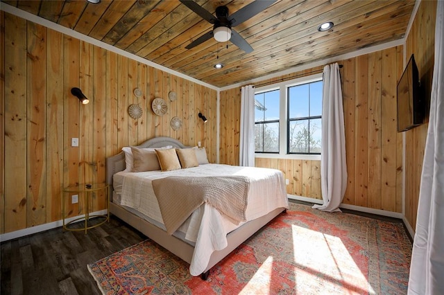 bedroom featuring wooden ceiling, wooden walls, baseboards, and wood finished floors