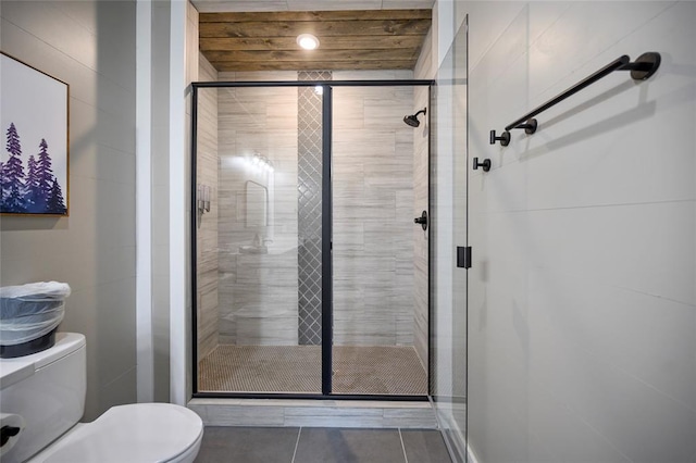 bathroom with a shower stall and toilet