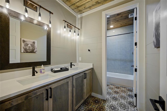 full bathroom featuring double vanity, tile patterned flooring, and a sink