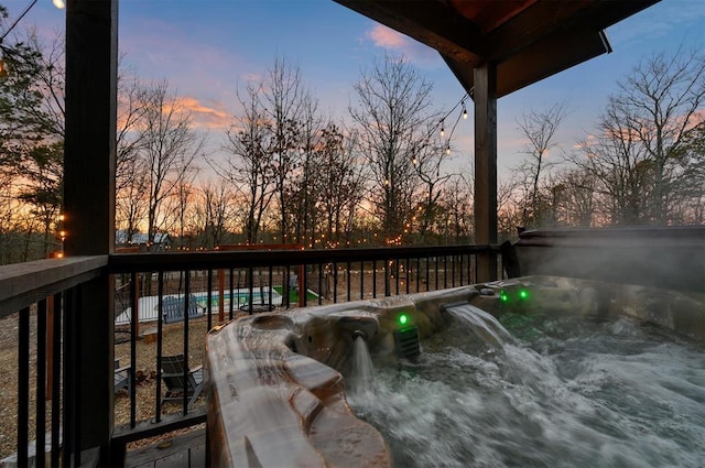 wooden terrace with a hot tub