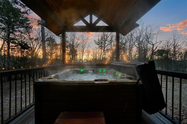 wooden deck featuring a hot tub