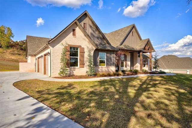 view of front of home with a front yard and a garage