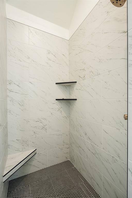 bathroom with tiled shower