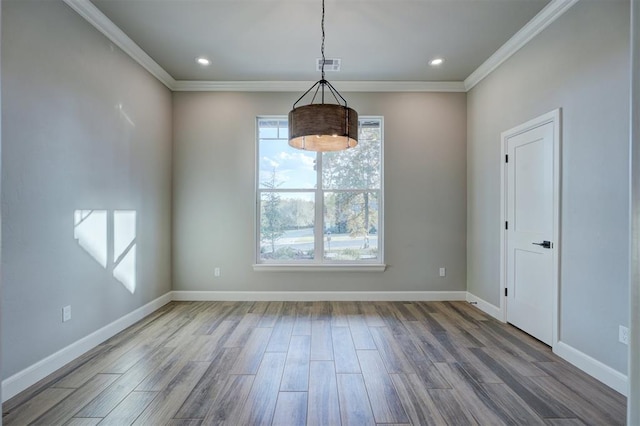 empty room featuring hardwood / wood-style flooring and ornamental molding