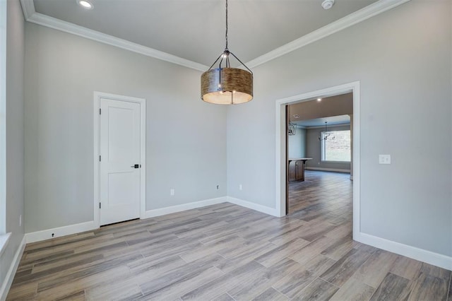 unfurnished room featuring crown molding and light hardwood / wood-style flooring