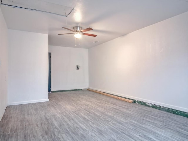 spare room with hardwood / wood-style floors and ceiling fan