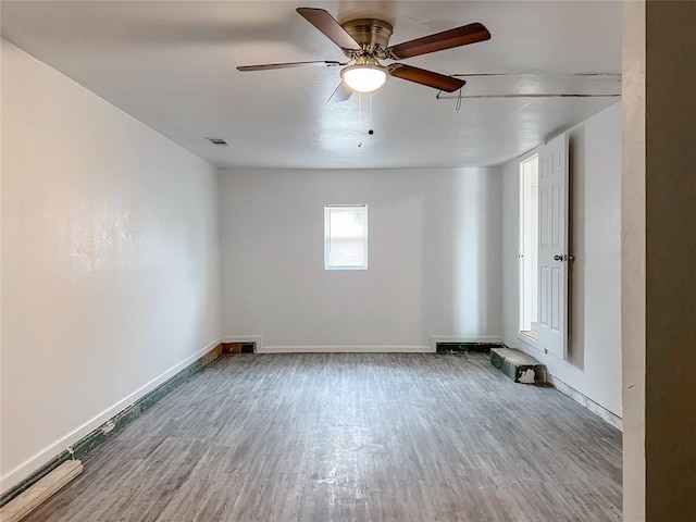 spare room with wood-type flooring and ceiling fan