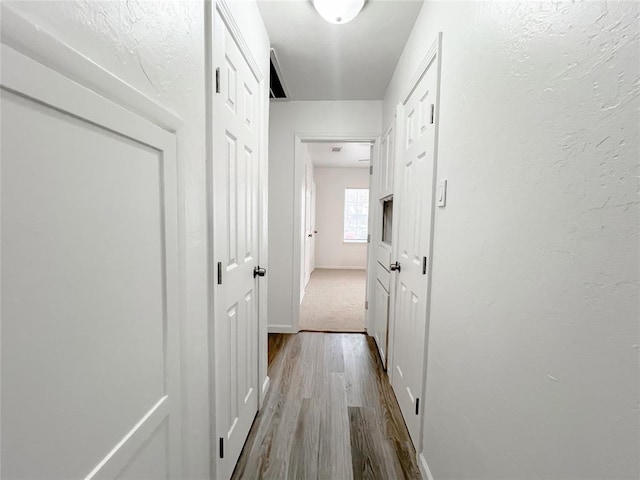 corridor with light wood-type flooring