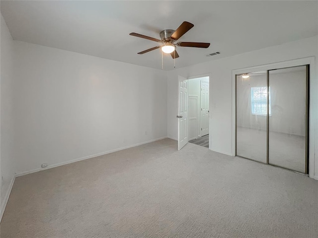 unfurnished bedroom featuring light carpet and ceiling fan