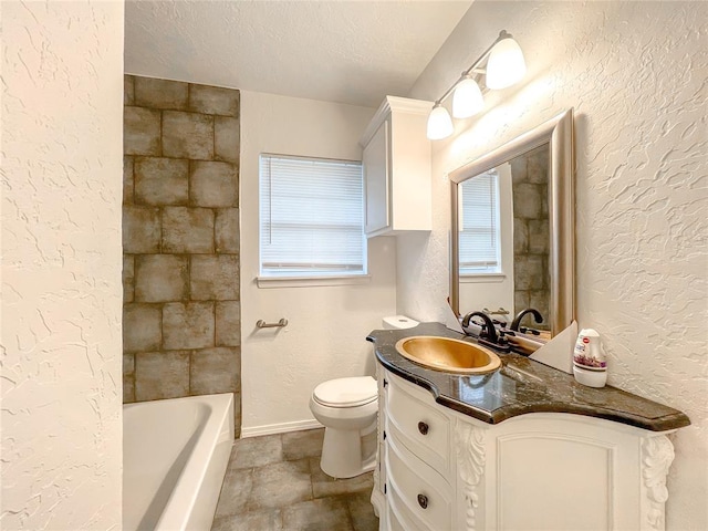 bathroom featuring vanity, a textured ceiling, and toilet