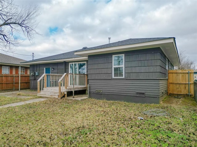 rear view of house featuring a lawn