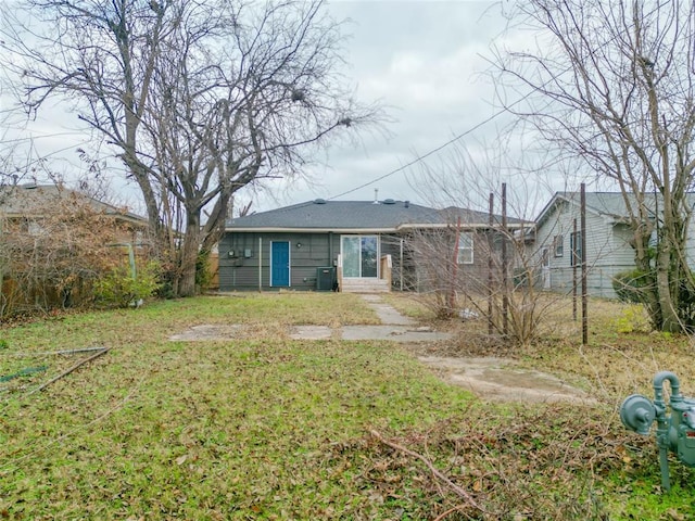 rear view of property with a yard and central AC unit