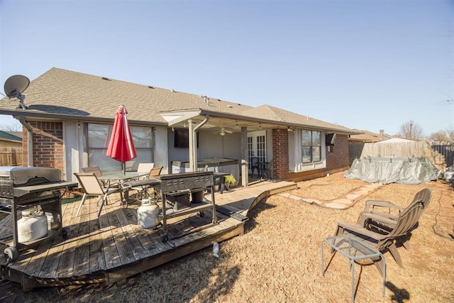 rear view of house with a jacuzzi and a deck