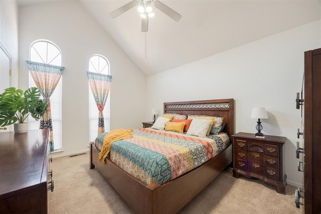 bedroom with ceiling fan, light carpet, and high vaulted ceiling