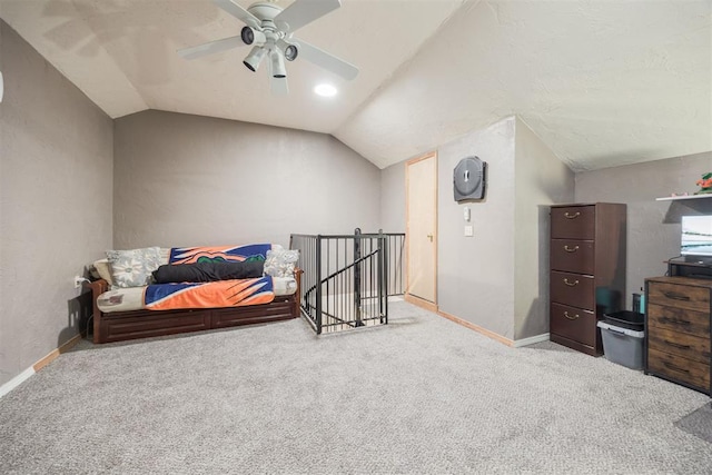 carpeted bedroom with vaulted ceiling and ceiling fan