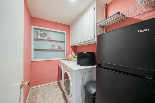 clothes washing area featuring cabinets and independent washer and dryer