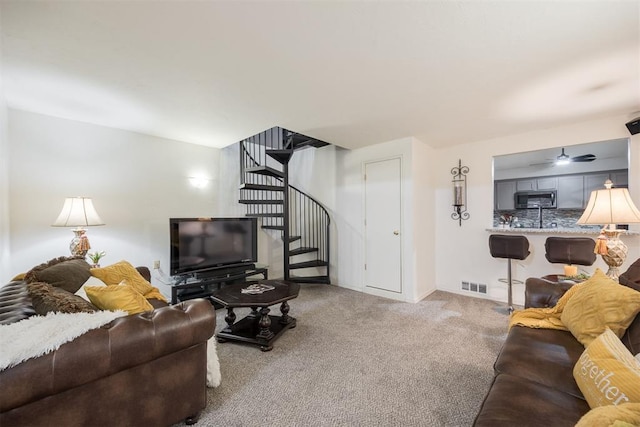 carpeted living room featuring ceiling fan