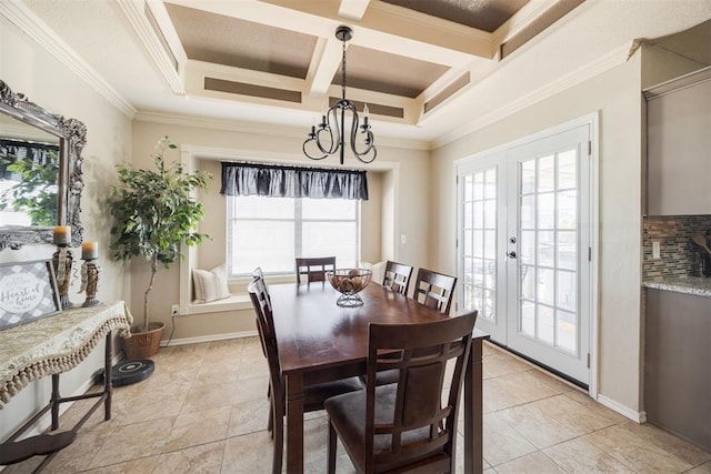 tiled dining area with ornamental molding, coffered ceiling, a notable chandelier, and french doors