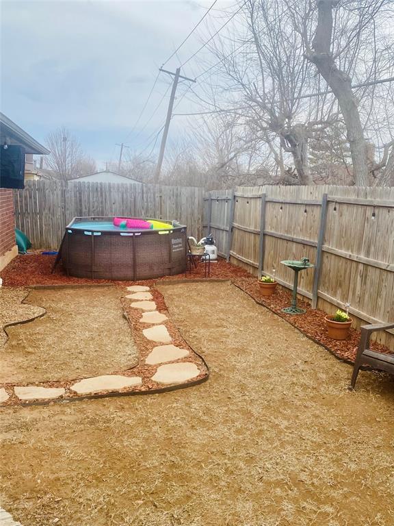 view of yard with a fenced backyard and a fenced in pool