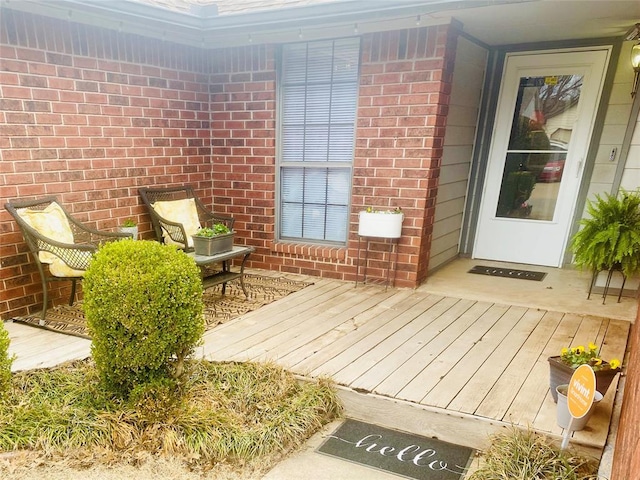 doorway to property with brick siding