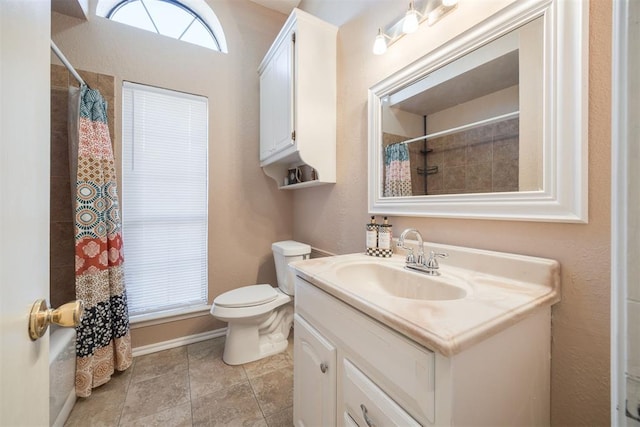 bathroom with toilet, a shower with shower curtain, vanity, baseboards, and tile patterned floors