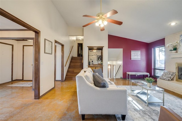 living room featuring ceiling fan, high vaulted ceiling, and a brick fireplace