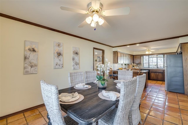 dining area featuring ceiling fan, ornamental molding, sink, and light tile patterned floors