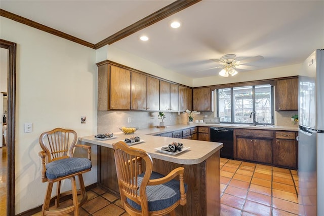 kitchen featuring stainless steel fridge, black dishwasher, a kitchen bar, decorative backsplash, and kitchen peninsula