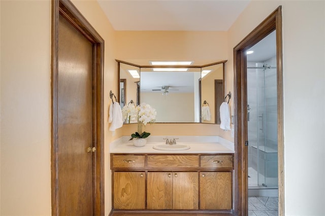 bathroom featuring vanity, ceiling fan, and walk in shower