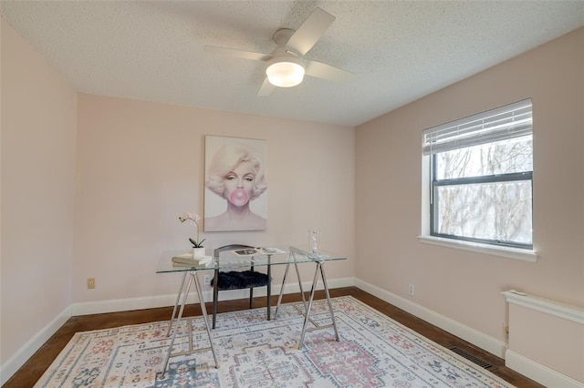 office area featuring ceiling fan and a textured ceiling